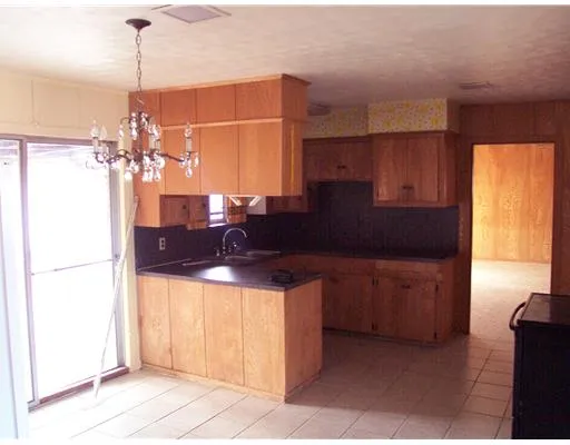 a kitchen with a sink a refrigerator and cabinets
