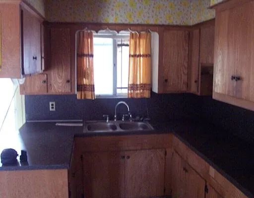 a kitchen with a sink cabinets and window