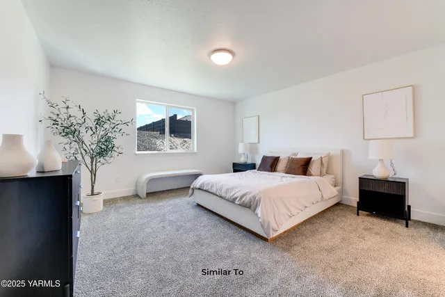 a spacious bedroom with a bed and a potted plant