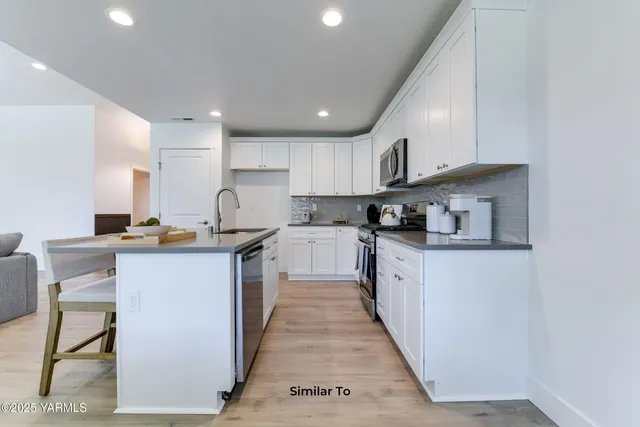 a kitchen with counter top space cabinets and stainless steel appliances