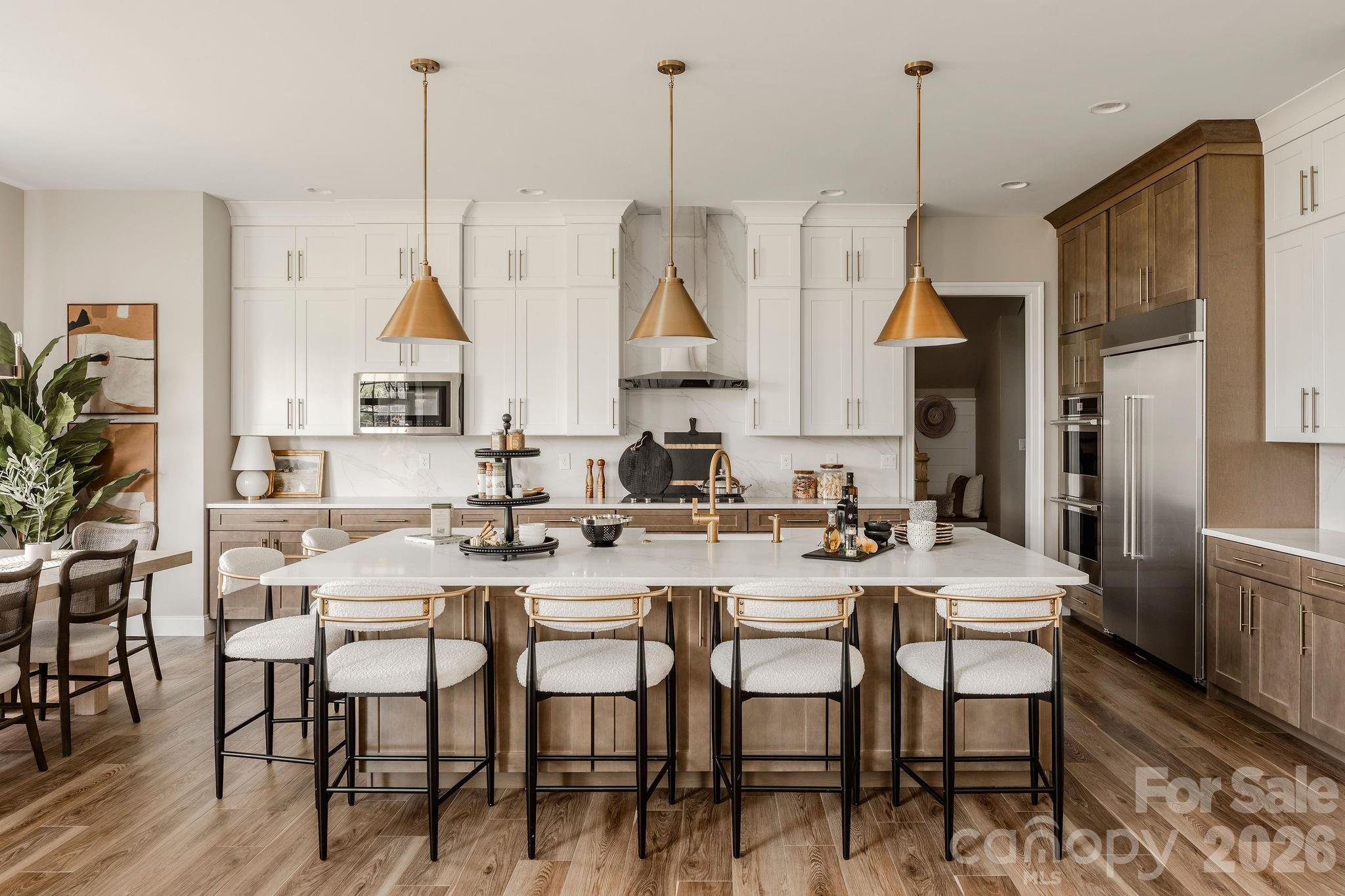 200 Ervin Road, Unit DEVONSHIRE Mooresville, NC 28117 - Photo 15 of 46 a view of a dining room and livingroom with furniture wooden floor a chandelier