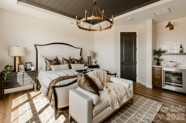 a bedroom with bed and a chandelier