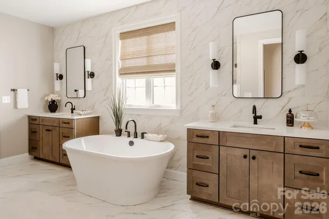 a bathroom with a double vanity sink mirror and bathtub