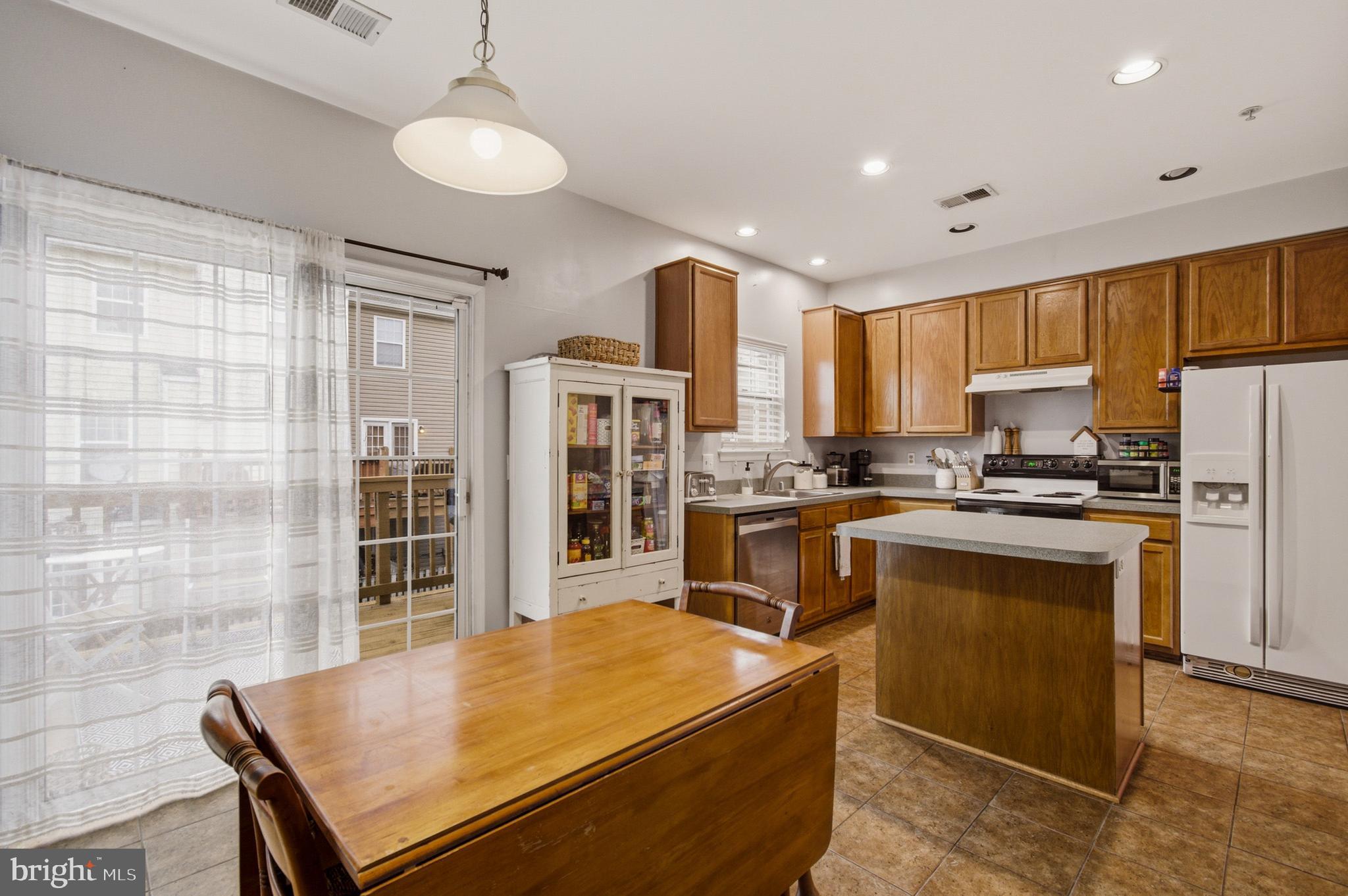 1212 Needham Court Crofton, MD 21114 - Photo 23 of 47 a kitchen with stainless steel appliances granite countertop a refrigerator a stove top oven a sink and dishwasher