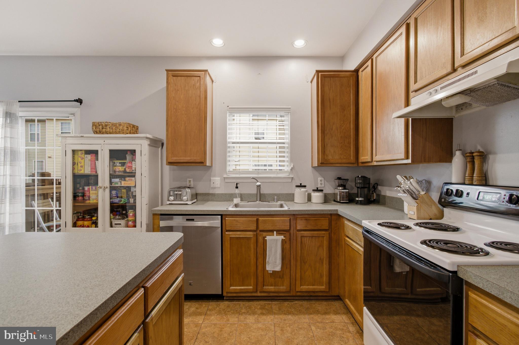1212 Needham Court Crofton, MD 21114 - Photo 24 of 47 a kitchen with stainless steel appliances a sink stove and cabinets