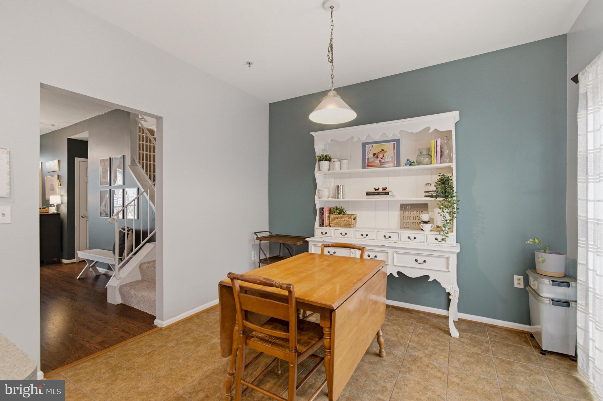 1212 Needham Court Crofton, MD 21114 - Photo 26 of 47 a room with table chairs and wooden floor