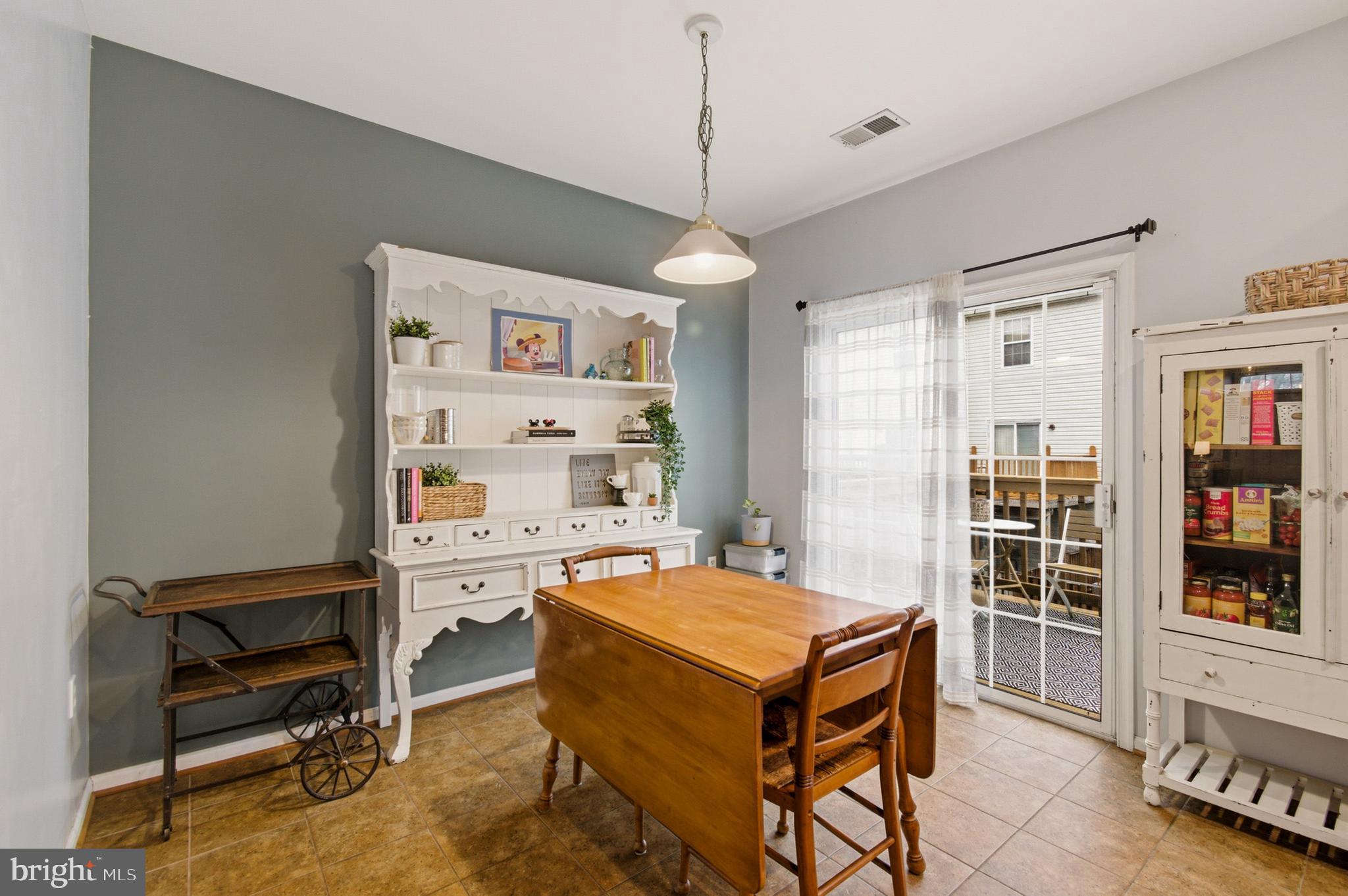 1212 Needham Court Crofton, MD 21114 - Photo 27 of 47 a room with a table chairs and a book shelf