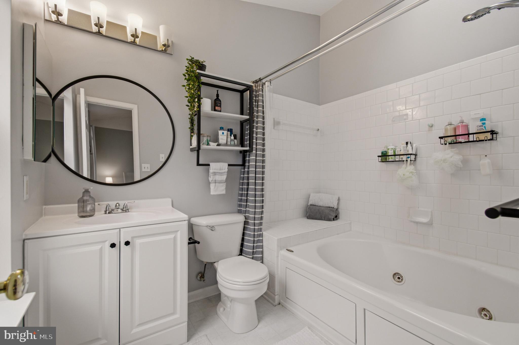 1212 Needham Court Crofton, MD 21114 - Photo 35 of 47 a bathroom with a toilet sink vanity tub and mirror