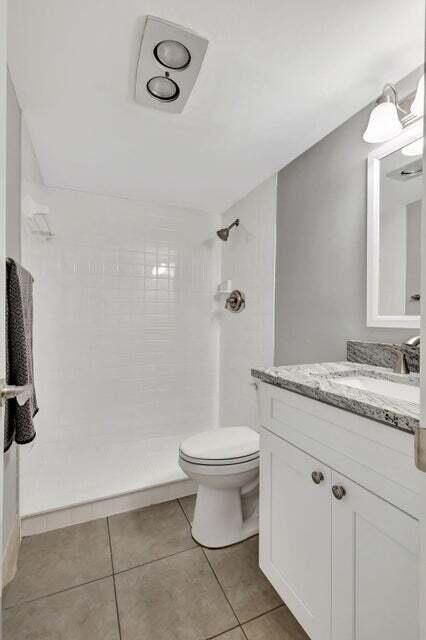27 Camden B West Palm Beach, FL 33417 - Photo 16 of 34 a bathroom with a granite countertop sink a toilet and a mirror