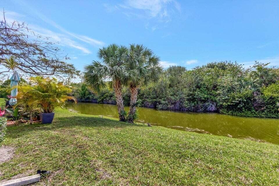 27 Camden B West Palm Beach, FL 33417 - Photo 23 of 34 a view of yard with swimming pool and green space
