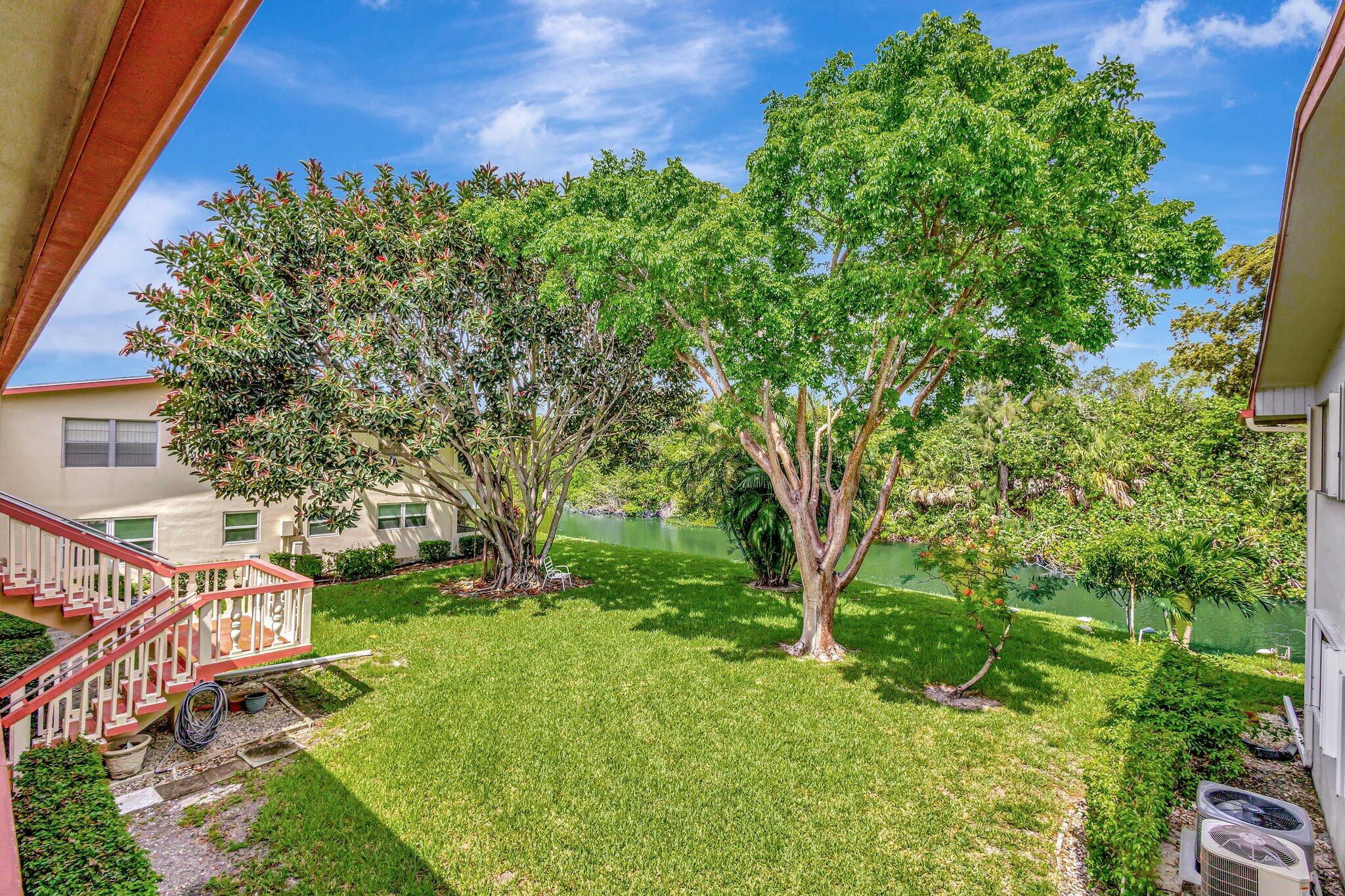27 Camden B West Palm Beach, FL 33417 - Photo 30 of 34 a view of an house with backyard and a tree
