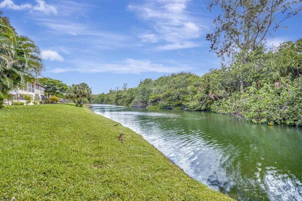 27 Camden B West Palm Beach, FL 33417 - Photo 32 of 34 a view of a lake with a yard