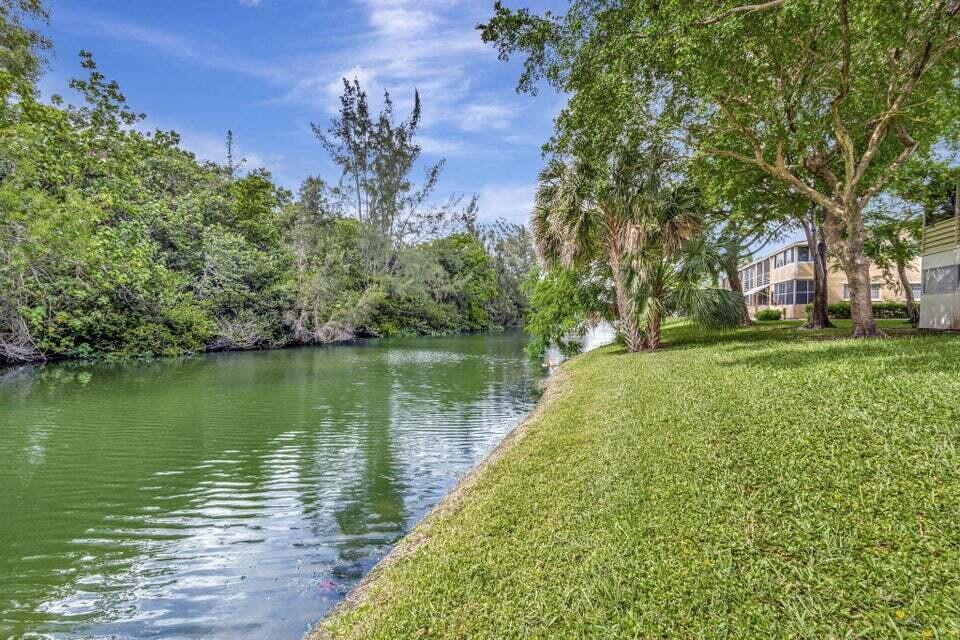 27 Camden B West Palm Beach, FL 33417 - Photo 33 of 34 a view of a lake with a garden