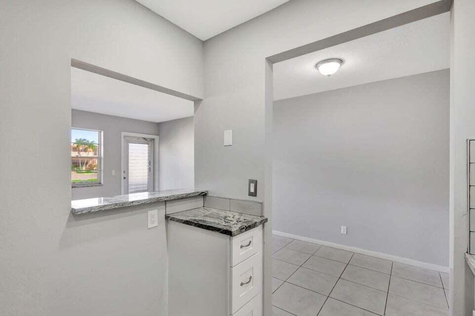 27 Camden B West Palm Beach, FL 33417 - Photo 8 of 34 a bathroom with a sink and a mirror