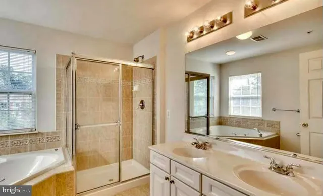 a bathroom with a sink a mirror and shower