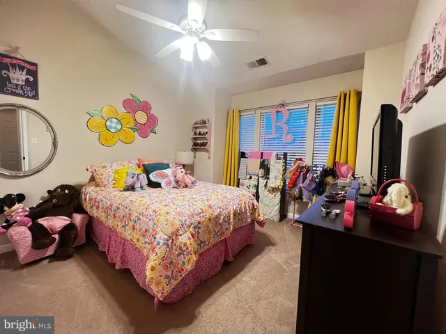 a bedroom with bed and a flat tv screen