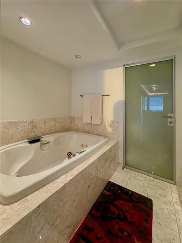 a bath tub sitting in a bathroom next to a sink