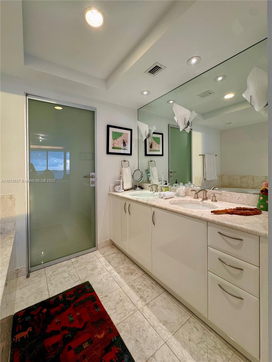 1331 Brickell Bay Drive, Unit 1505 Miami, FL 33131 - Photo 12 of 18 a spacious bathroom with a sink a large mirror and a shower