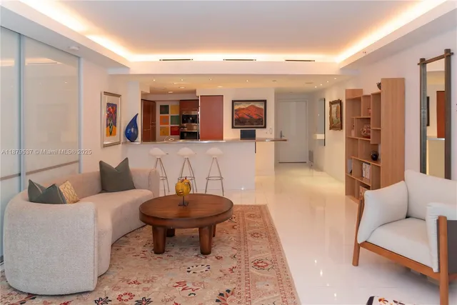 a living room with furniture and a large mirror