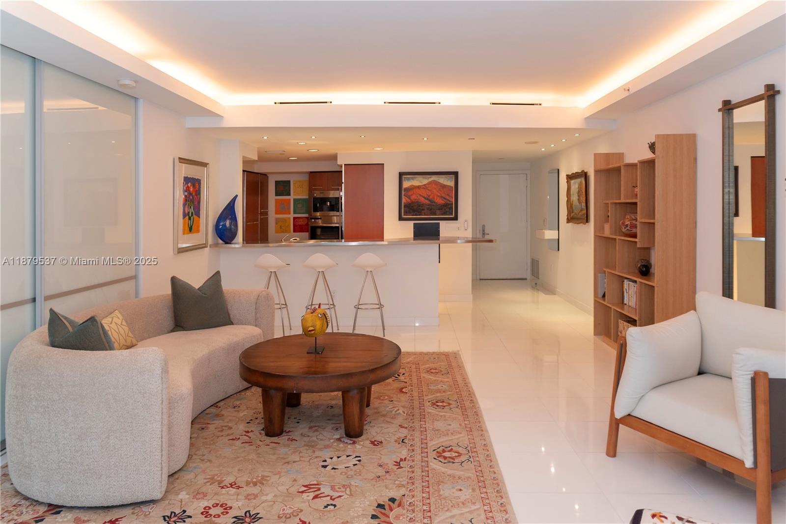 1331 Brickell Bay Drive, Unit 1505 Miami, FL 33131 - Photo 6 of 18 a living room with furniture and a large mirror