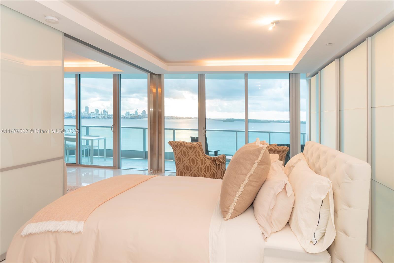 1331 Brickell Bay Drive, Unit 1505 Miami, FL 33131 - Photo 8 of 18 a bedroom with a bed and a large window