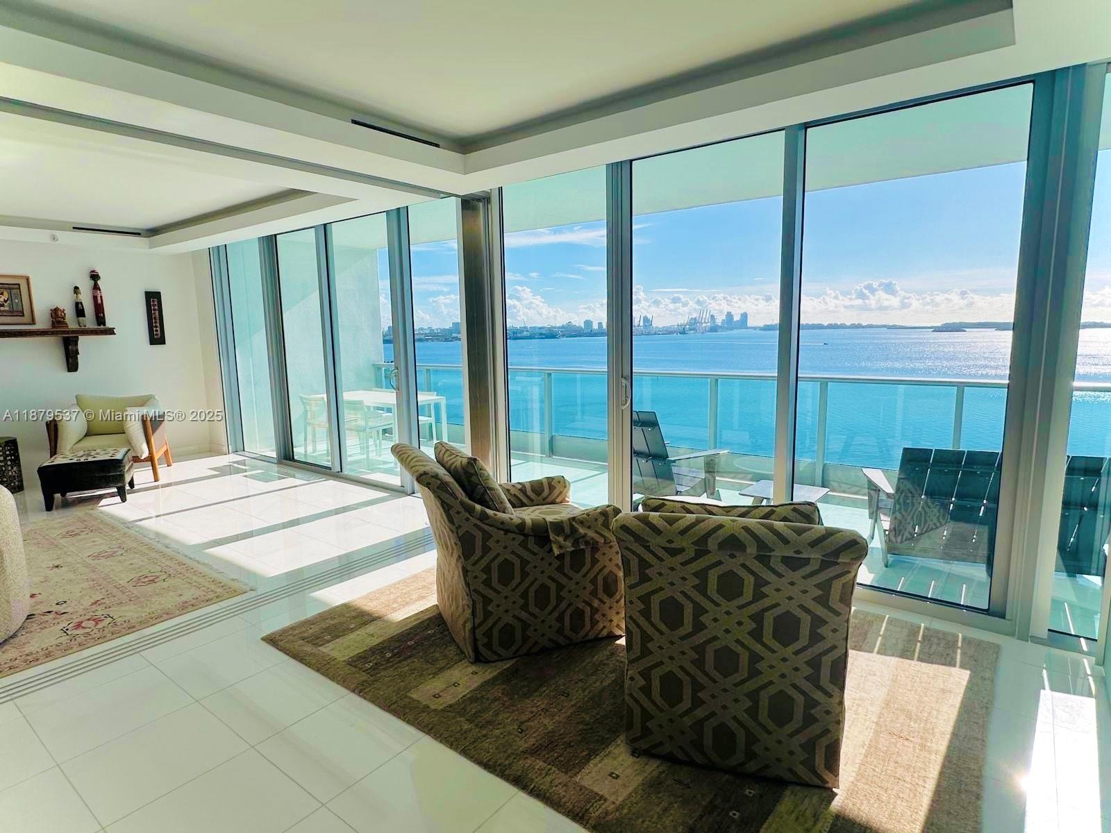 1331 Brickell Bay Drive, Unit 1505 Miami, FL 33131 - Photo 9 of 18 a living room with furniture and large windows