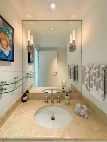 a bathroom with a sink double vanity and a mirror