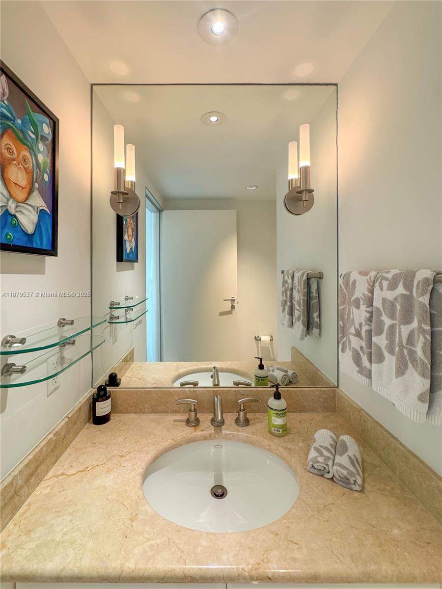 1331 Brickell Bay Drive, Unit 1505 Miami, FL 33131 - Photo 10 of 18 a bathroom with a sink double vanity and a mirror