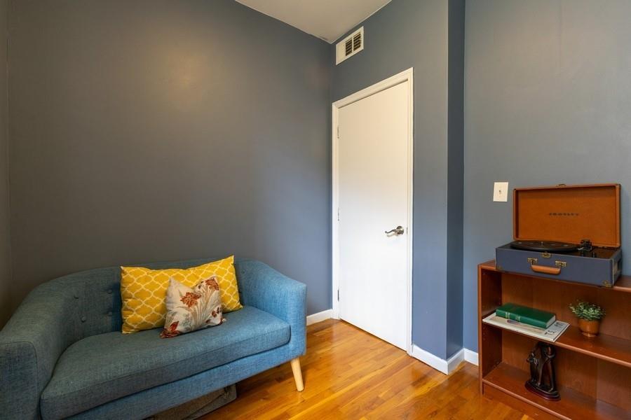 100 Ralph Avenue, Unit 2L Brooklyn, NY 11221 - Photo 12 of 15 a living room with furniture and a flat screen tv