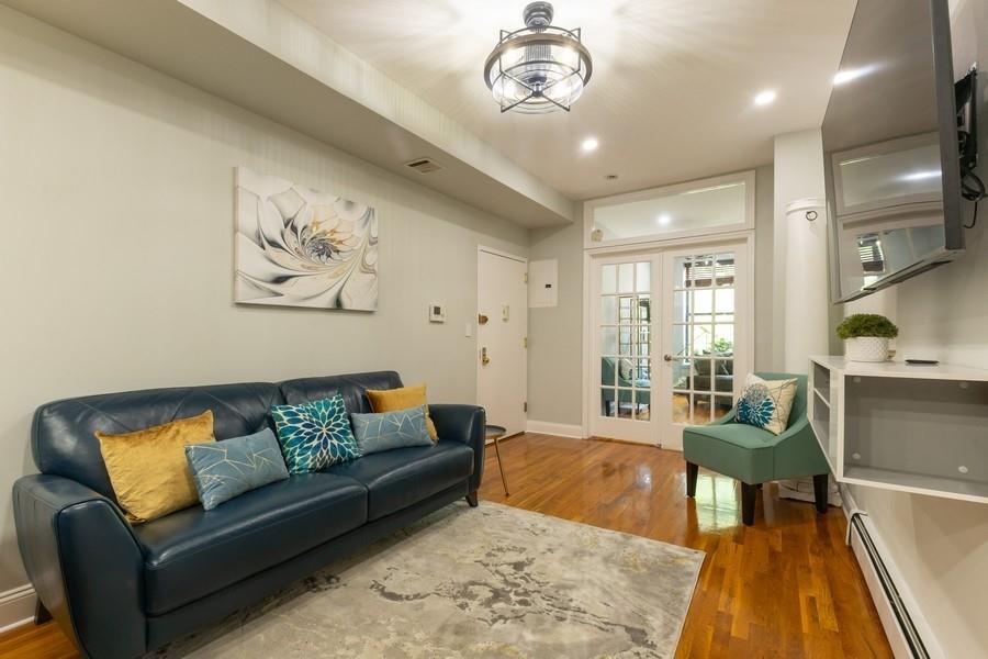100 Ralph Avenue, Unit 2L Brooklyn, NY 11221 - Photo 5 of 15 a living room with furniture and a chandelier