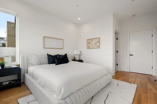 a large white bed in a white room
