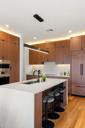 a kitchen with a table chairs refrigerator and cabinets