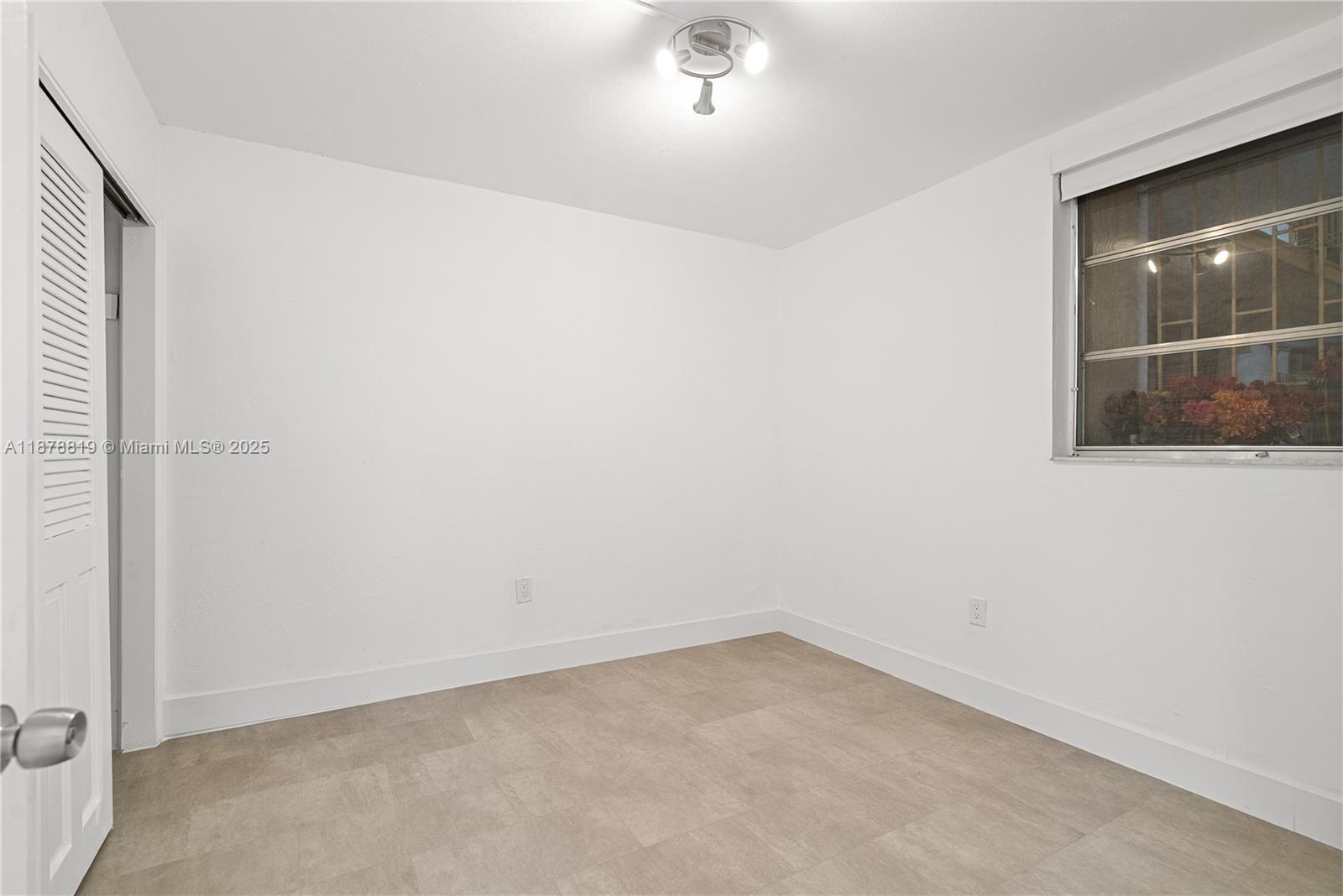 8305 Crespi Boulevard, Unit 2D Miami Beach, FL 33141 - Photo 14 of 33 an empty room with a window
