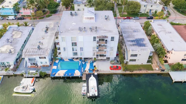 an aerial view of residential houses with outdoor space and swimming pool