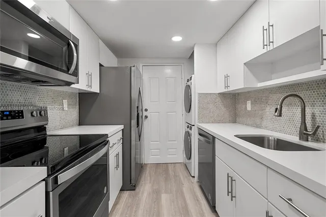 a kitchen with stainless steel appliances and wooden cabinets