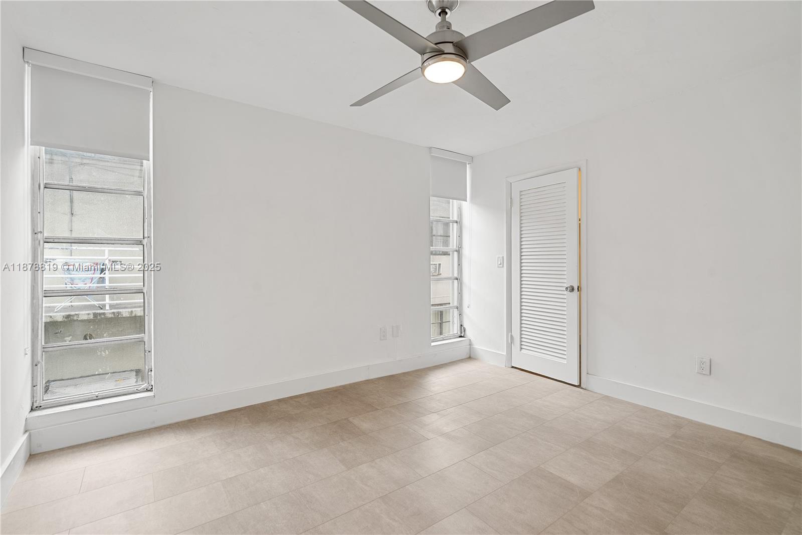 8305 Crespi Boulevard, Unit 2D Miami Beach, FL 33141 - Photo 8 of 33 an empty room with closet and a ceiling fan