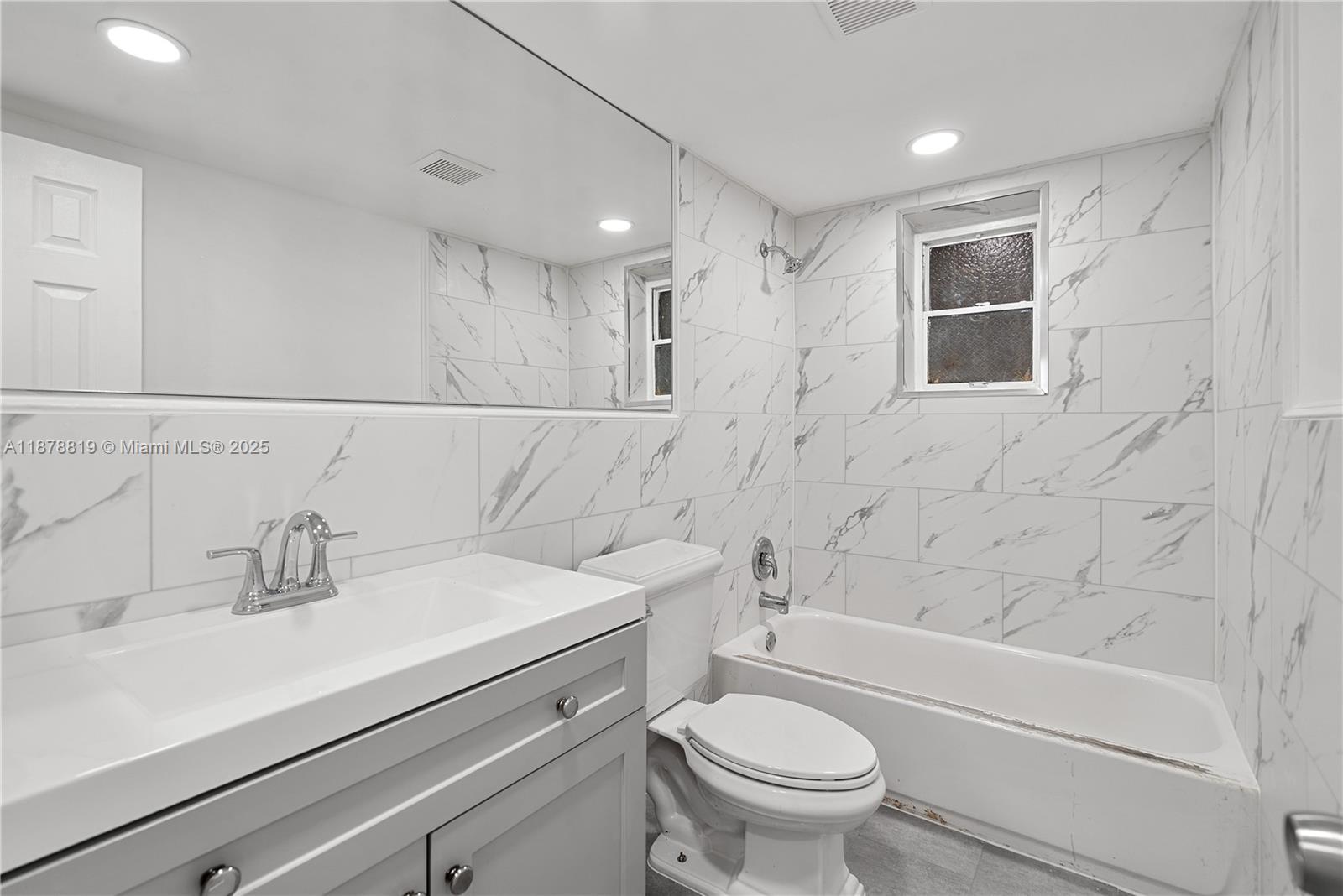 8305 Crespi Boulevard, Unit 2D Miami Beach, FL 33141 - Photo 10 of 33 a bathroom with a sink a toilet and shower