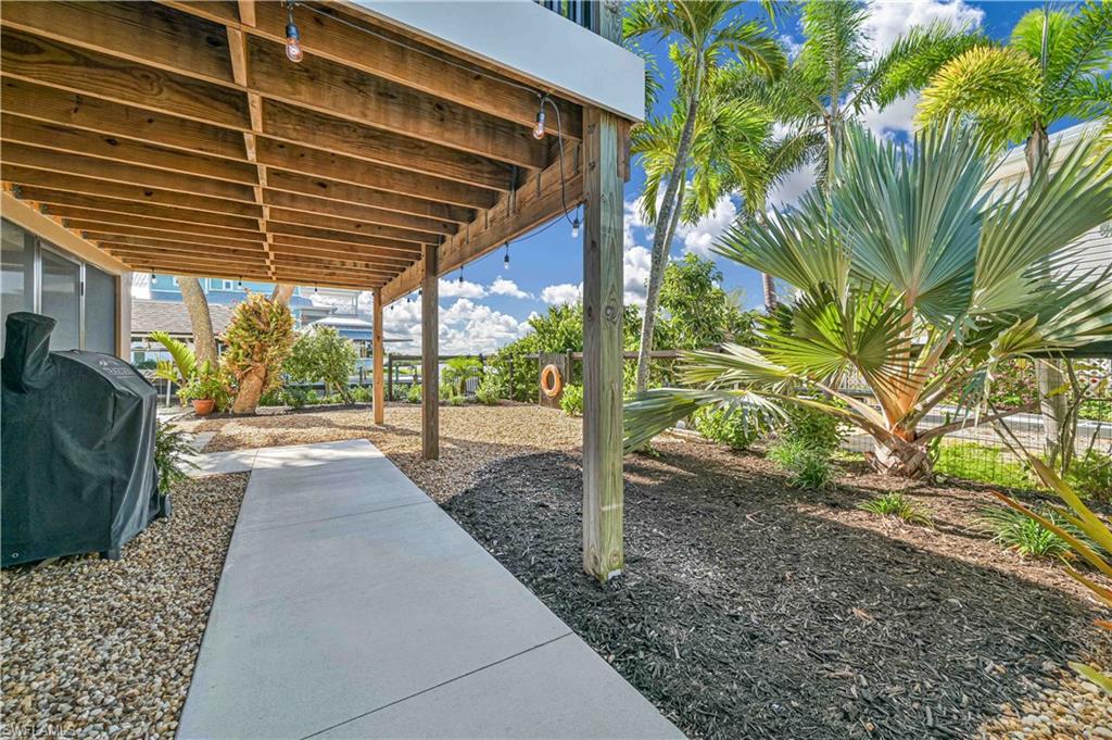 8117 Judge Bean Road Bokeelia, FL 33922 - Photo 29 of 38 Covered walk to back yard