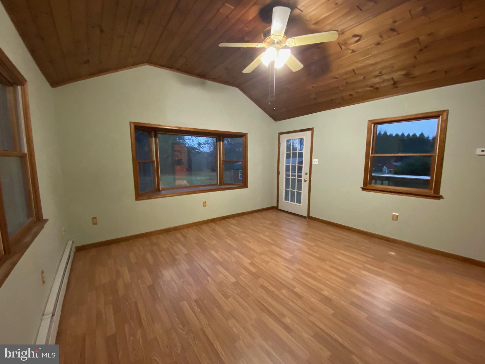 2012 Old Forty Foot Road Harleysville, PA 19438 - Photo 11 of 36 an empty room with wooden floor chandelier and windows