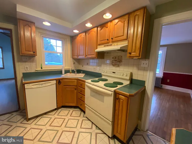 a kitchen with a sink cabinets and window