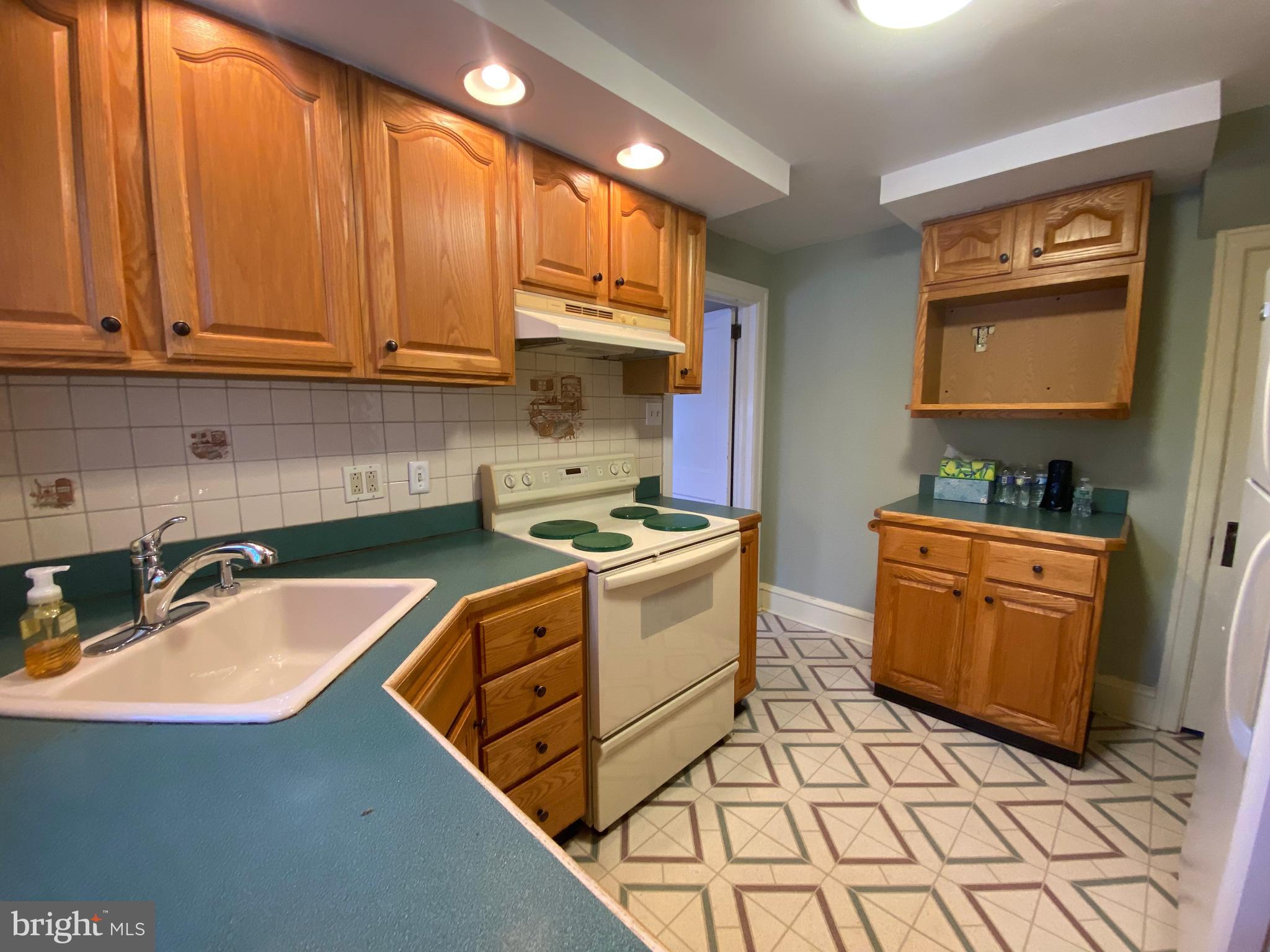 2012 Old Forty Foot Road Harleysville, PA 19438 - Photo 10 of 36 a kitchen with stainless steel appliances granite countertop a sink stove and cabinets