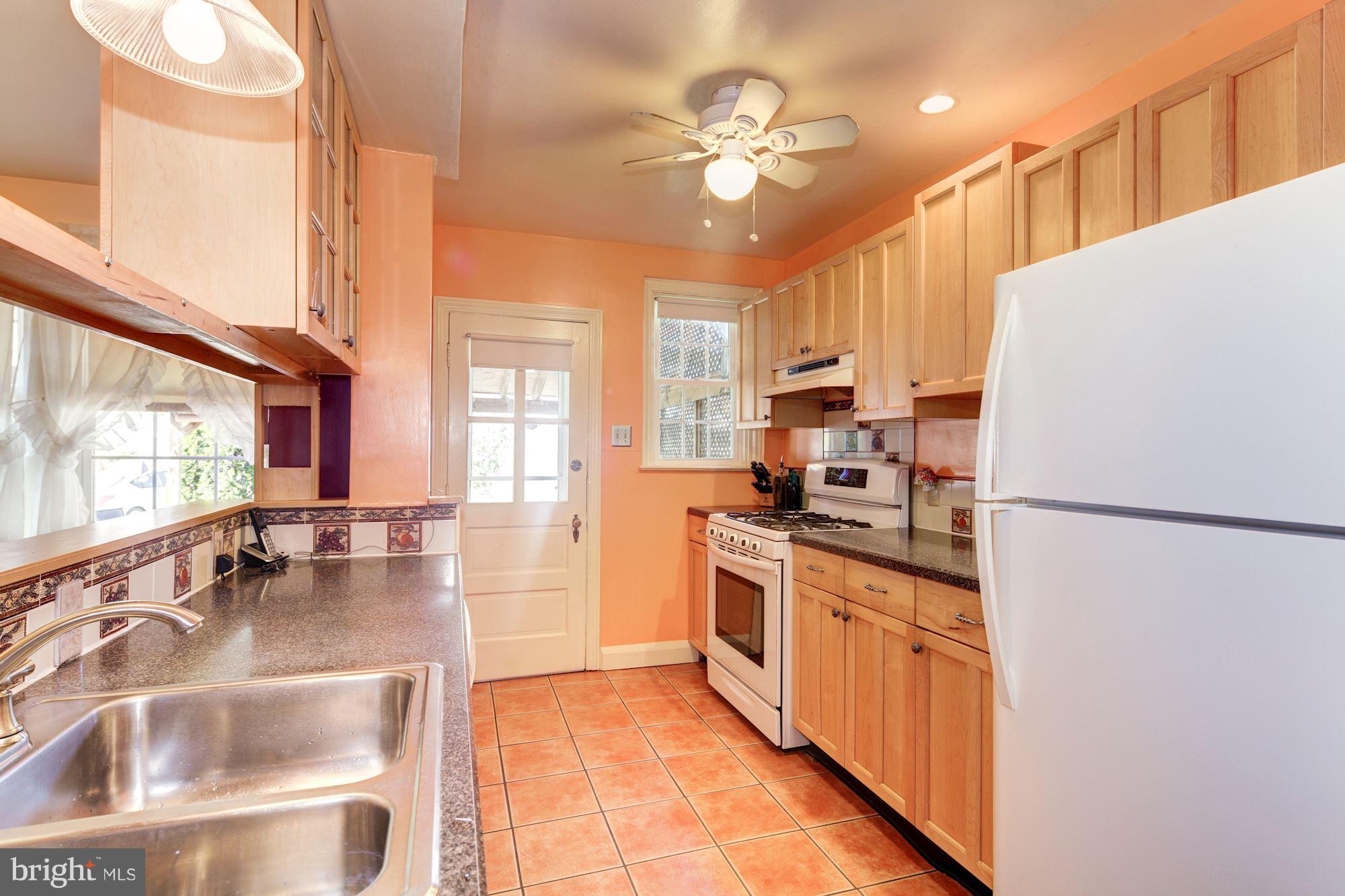 222 Ridge Avenue Baltimore, MD 21286 - Photo 11 of 30 a kitchen with stainless steel appliances a stove a refrigerator and a sink