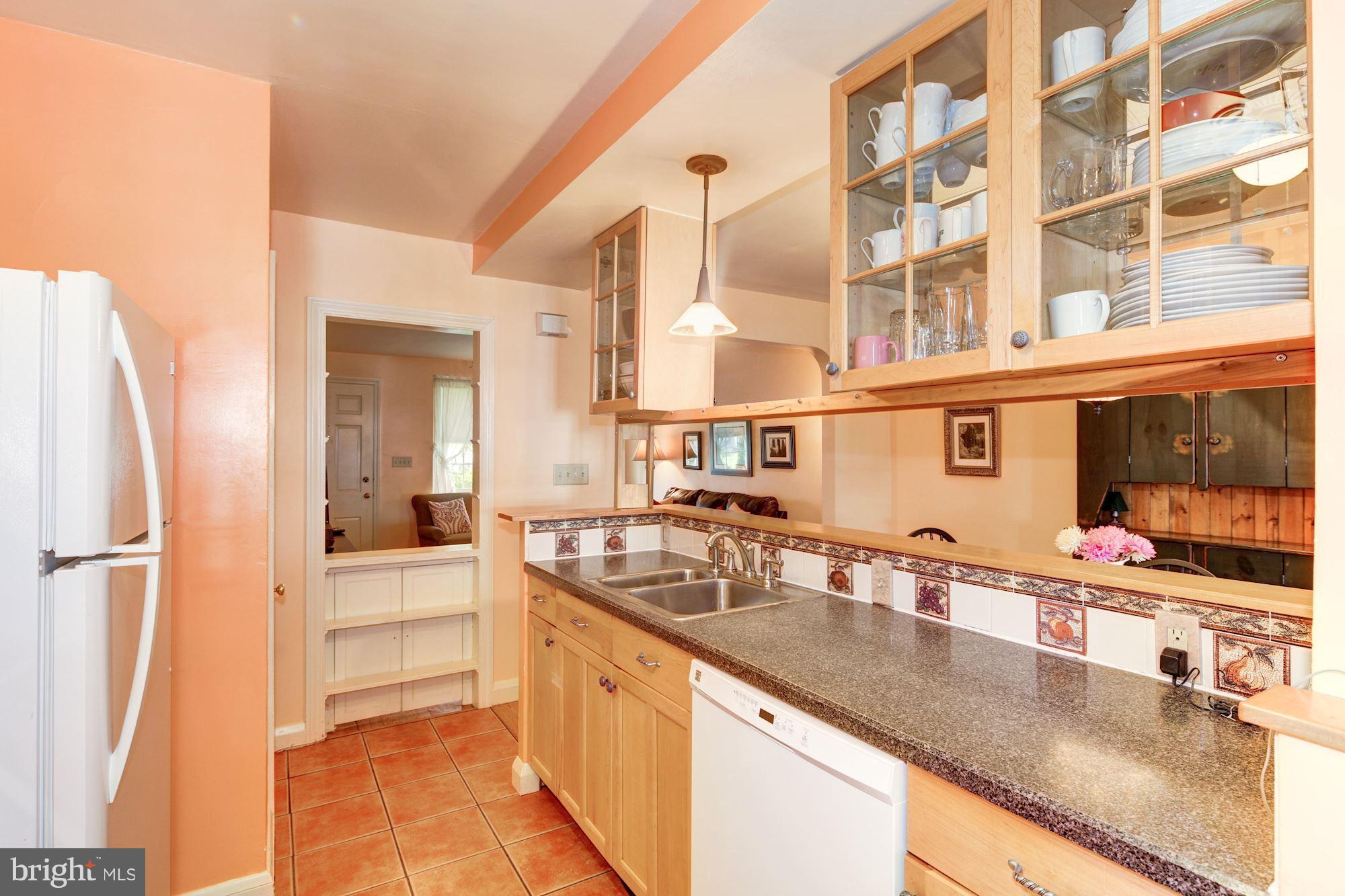 222 Ridge Avenue Baltimore, MD 21286 - Photo 13 of 30 a kitchen with stainless steel appliances granite countertop a sink and a refrigerator