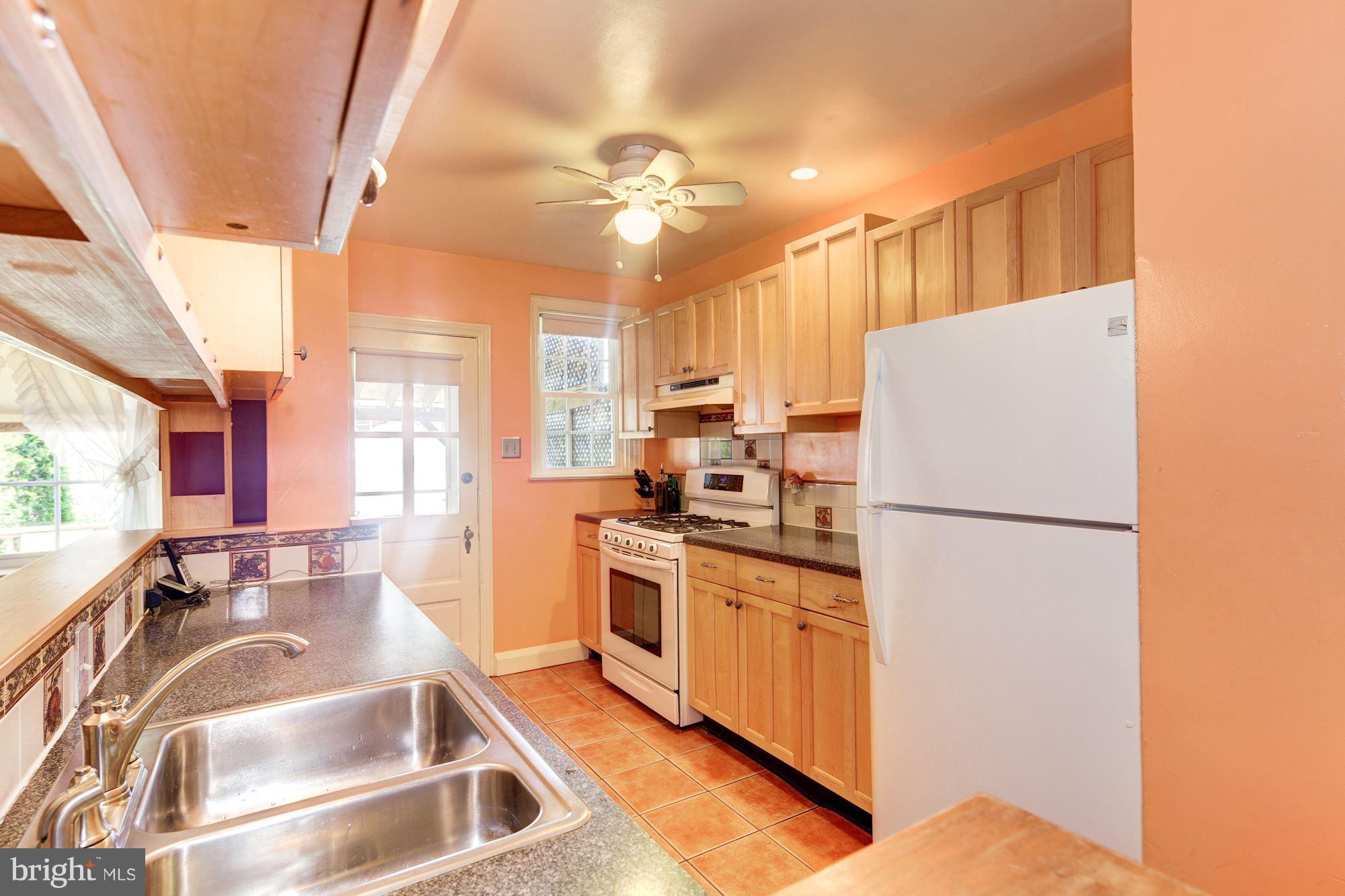 222 Ridge Avenue Baltimore, MD 21286 - Photo 15 of 30 a kitchen with a refrigerator a sink and a stove
