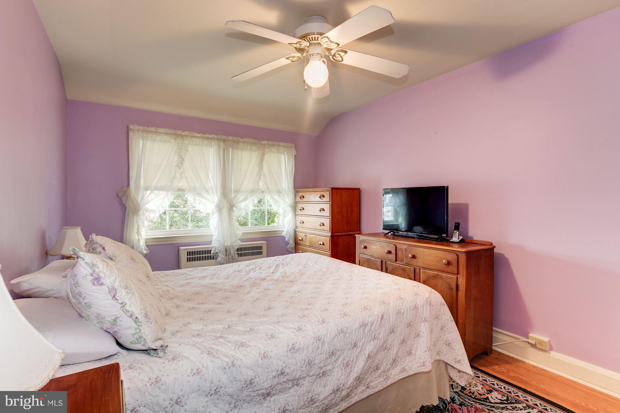 222 Ridge Avenue Baltimore, MD 21286 - Photo 17 of 30 a bedroom with a bed and a flat screen tv