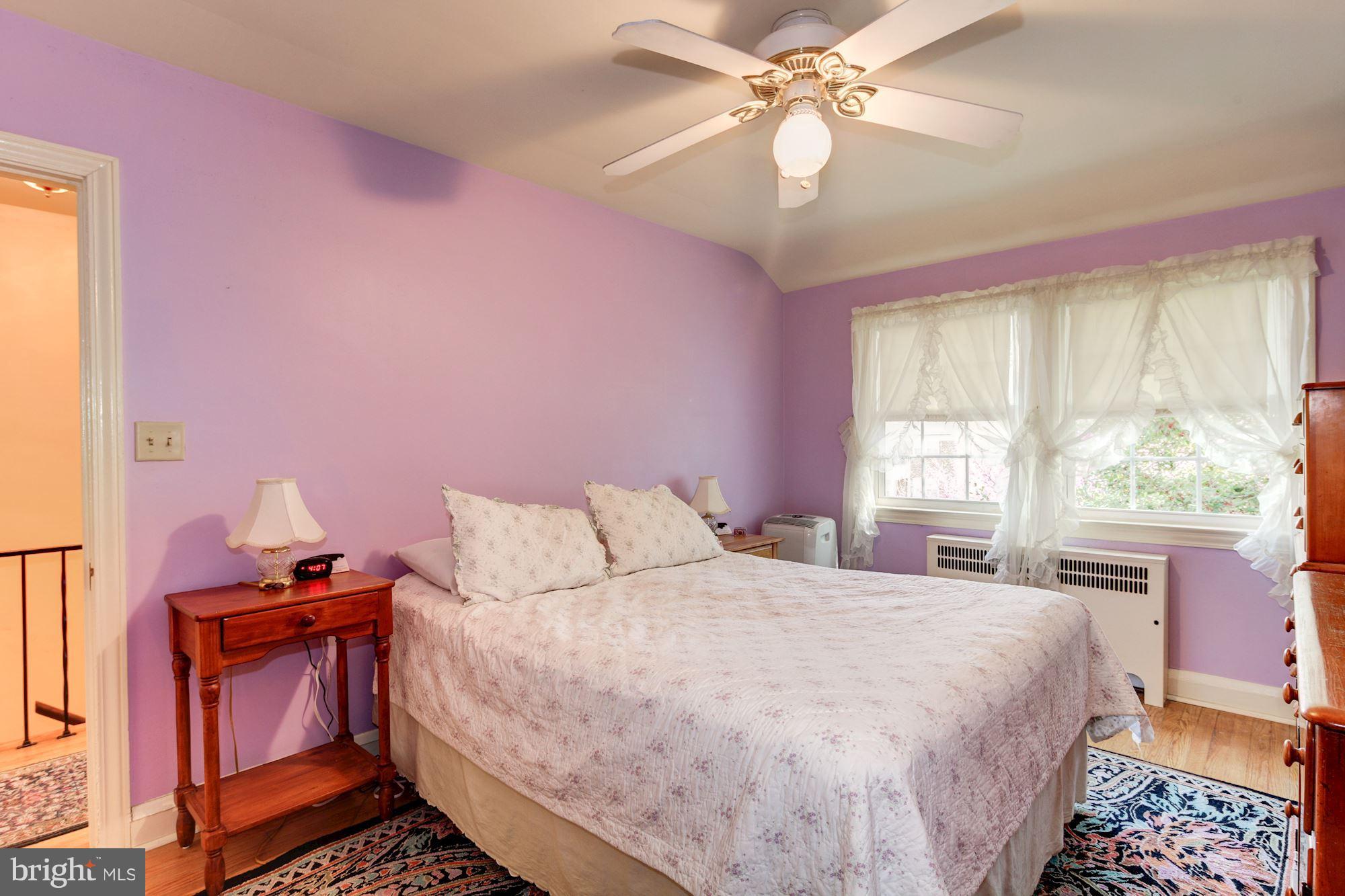 222 Ridge Avenue Baltimore, MD 21286 - Photo 18 of 30 a bedroom with a bed and a chandelier