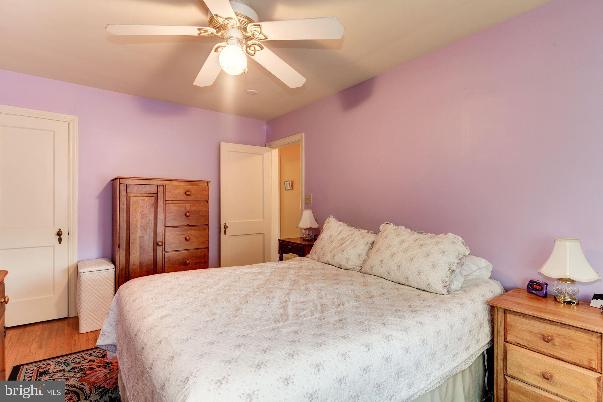 222 Ridge Avenue Baltimore, MD 21286 - Photo 19 of 30 a bedroom with a bed and a chandelier