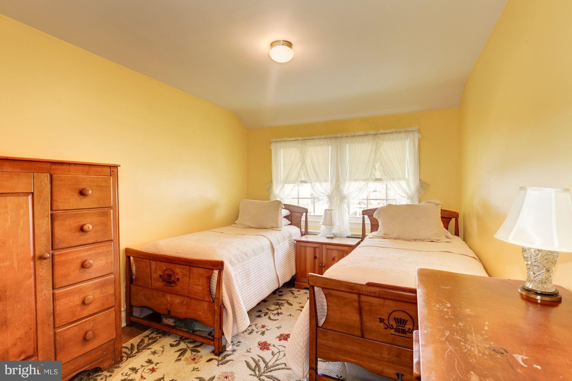 222 Ridge Avenue Baltimore, MD 21286 - Photo 20 of 30 a bedroom with a bed and a dresser