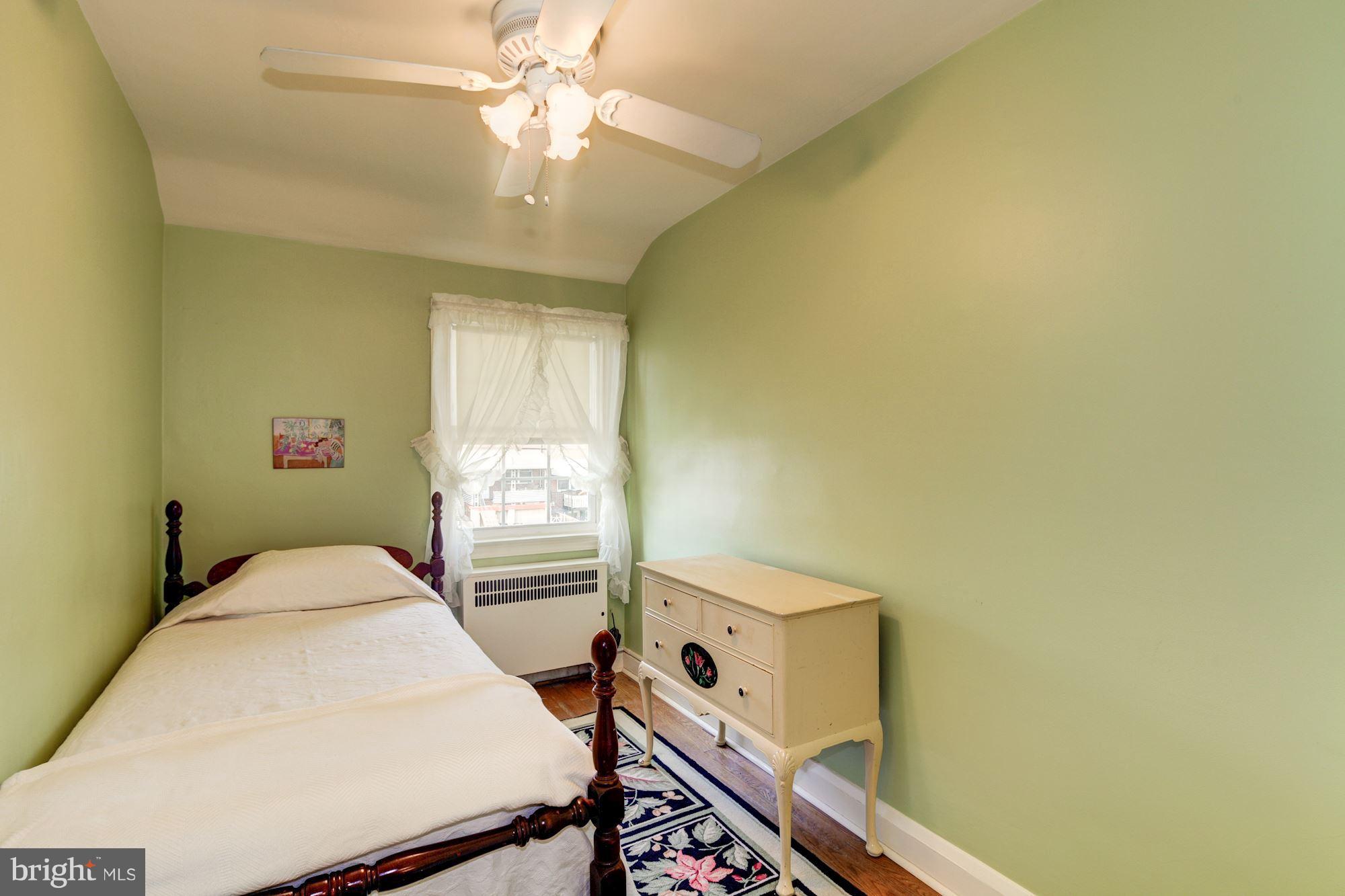 222 Ridge Avenue Baltimore, MD 21286 - Photo 21 of 30 a bedroom with a bed and a chandelier