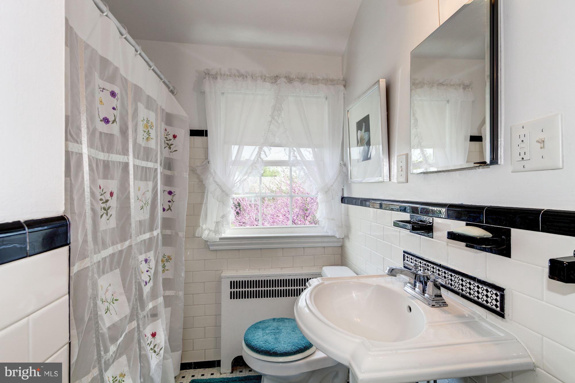 222 Ridge Avenue Baltimore, MD 21286 - Photo 22 of 30 a bathroom with a sink a toilet and a mirror